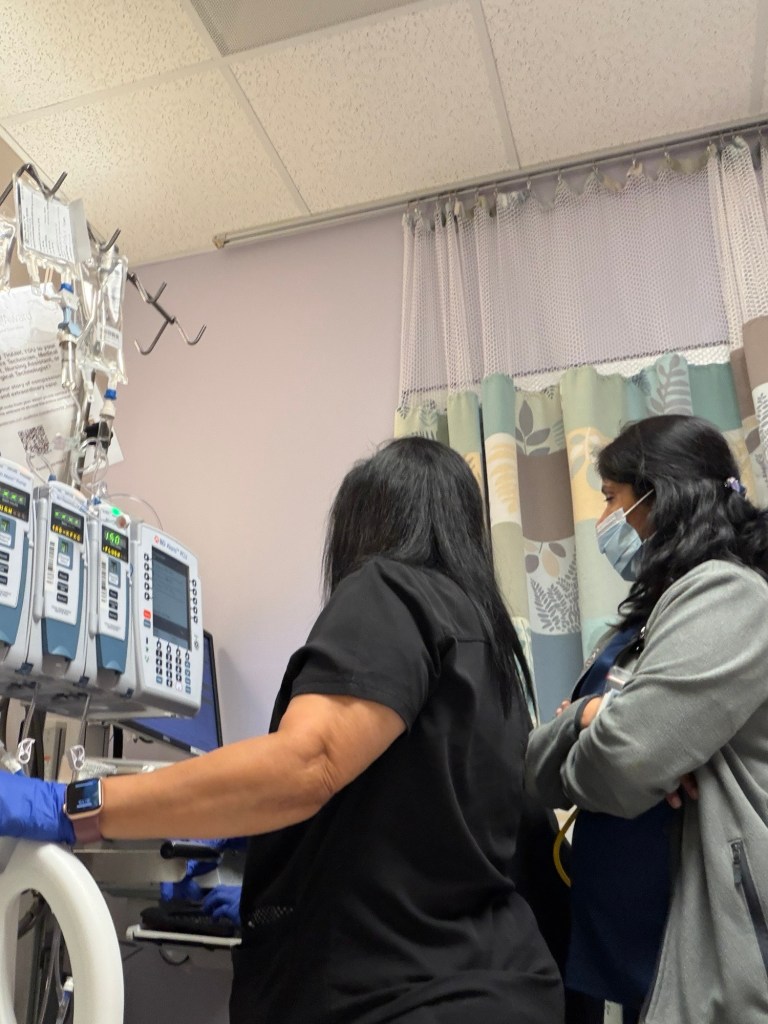 Two infusion nurses at the pumps during my initial MOGA infusion reaction